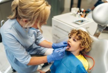 cute-young-boy-visiting-dentist-having-his-teeth-checked-by-female-dentist-dental-office